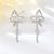 Picture of Butterfly White Tassel Earrings Online Only